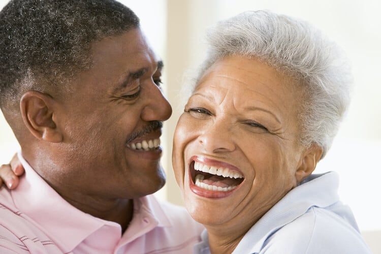 A happy senior couple smiling and laughing.