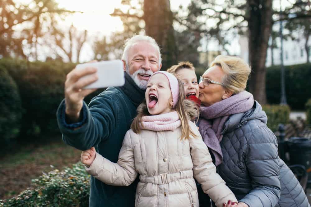 Grandparents take a selfie outside with their grandparents