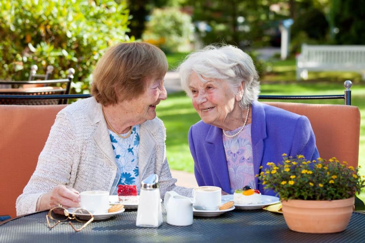 two senior women socializing over a meal