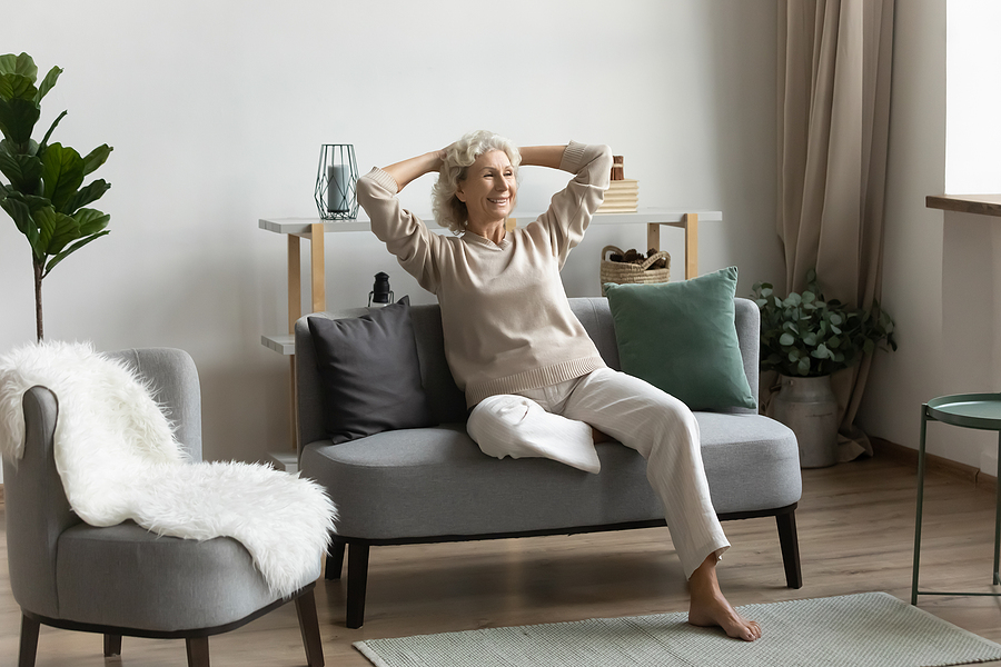 A senior woman relaxes in her stylish apartment