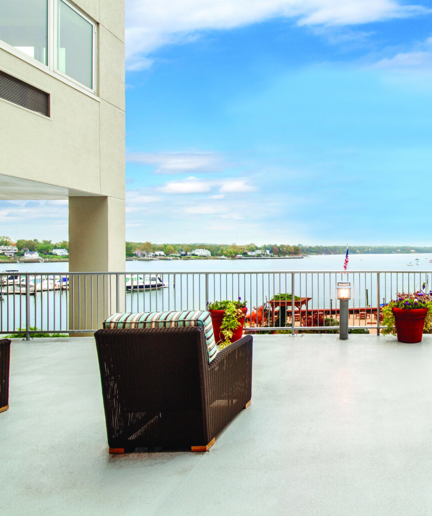 Outdoor shot of a deck with chairs overlooking the Harbor