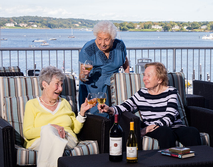 Seniors enjoying a glass of wine on a patio