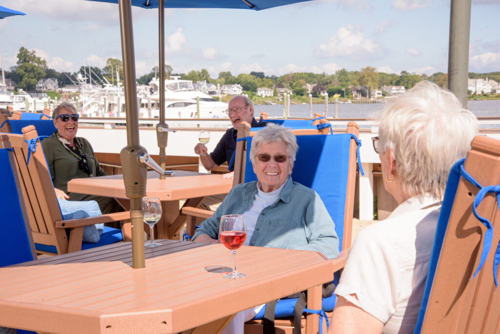 Seniors enjoying a sunny day outside drinking wine