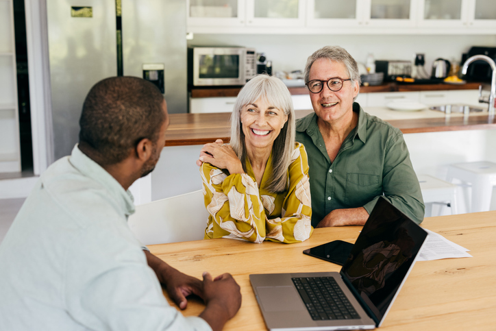 A senior couple meets with a team member