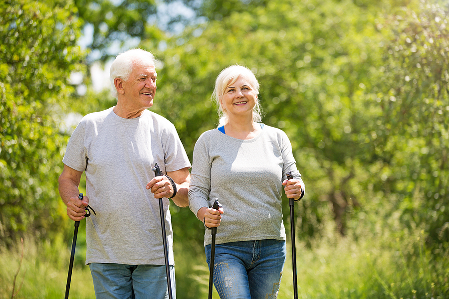 A senior couple tries Nordic walking.