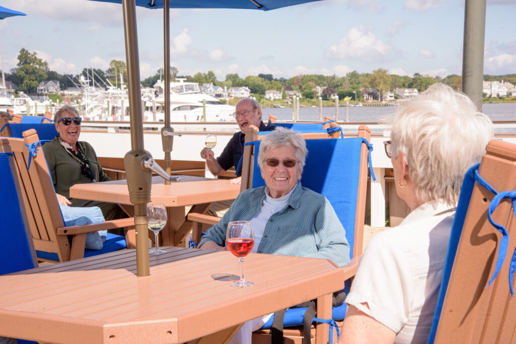 Seniors enjoying a glass of wine together outdoors