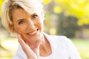 portrait of lovely middle aged woman sitting at the park