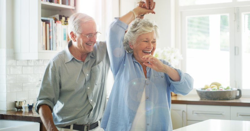 Shot of a happy senior couple dancing together at home
