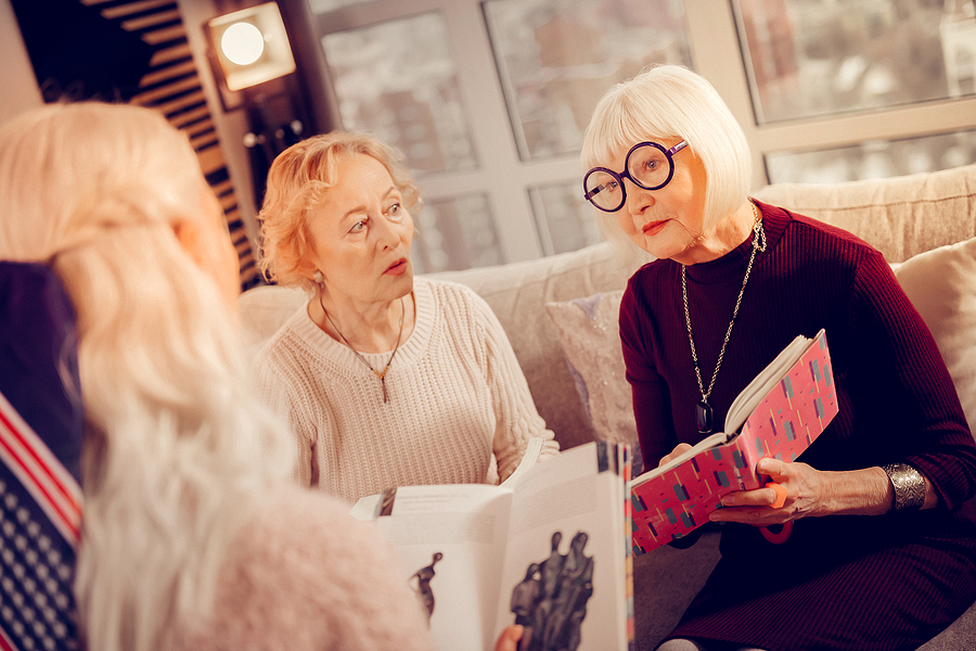 Older women gathered for a book club meeting
