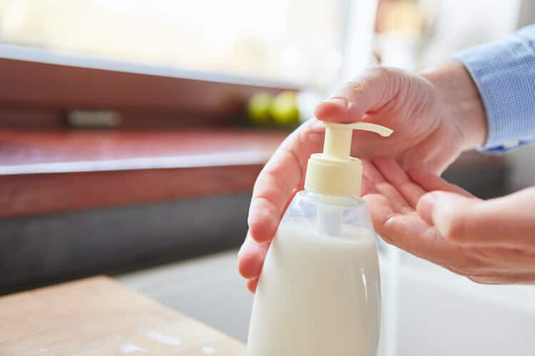 A senior washing hands in order to maintain good hygiene.
