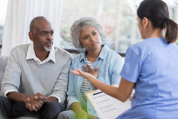 Senior Couple Talking to Nurse