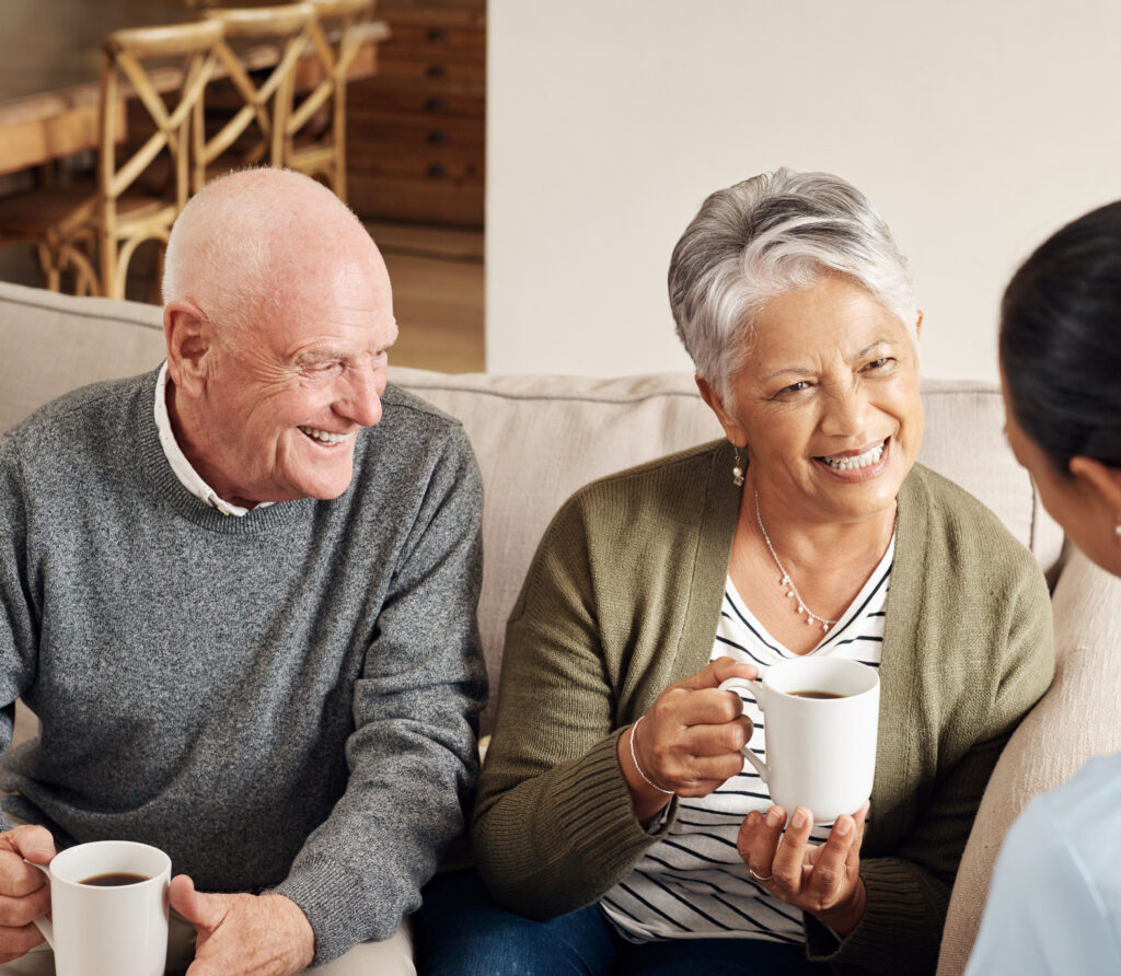 Senior Couple Smiling Meeting with Admin Nurse