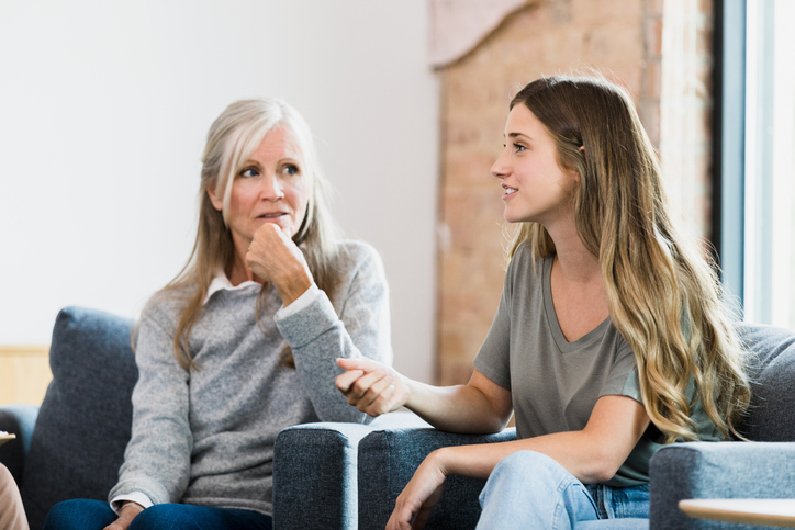 Adult daughter talks to mother about the benefits of living in a senior community