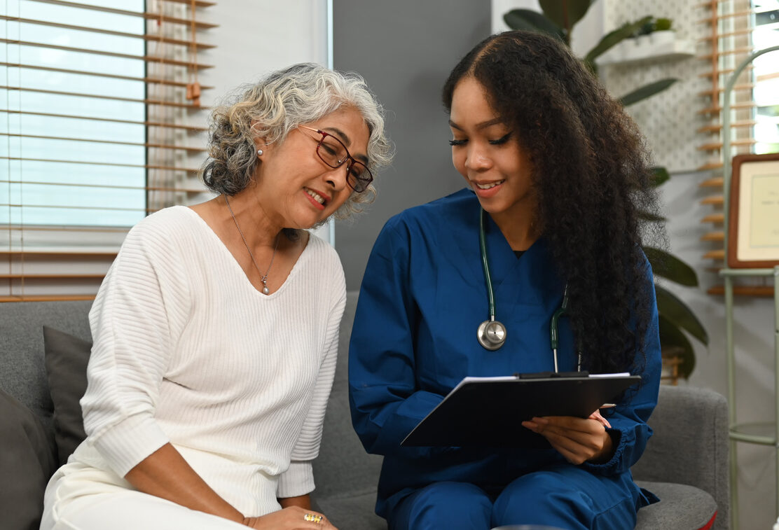 Senior Patient and Nurse Smiling at Each Other