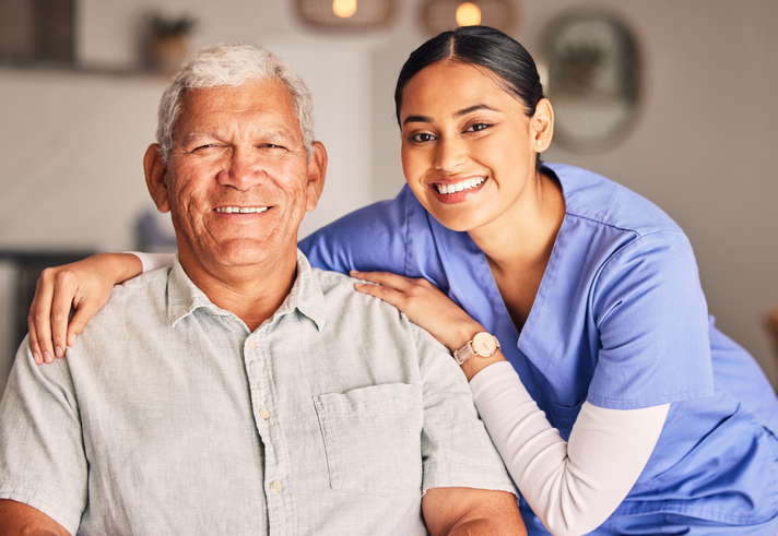 Nurse and Senior Patient Smiling at Camera