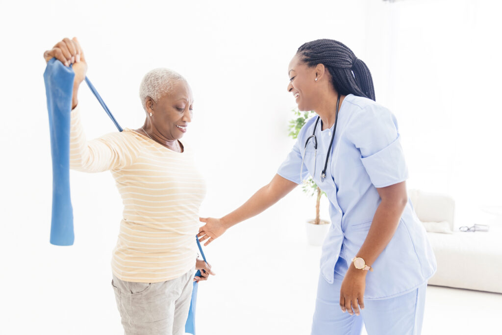 Senior Woman Smiling while Working with Physical Therapist