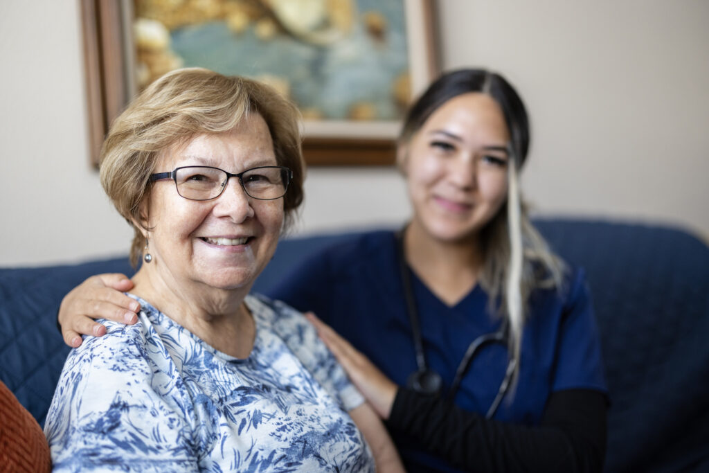 Nurse and Senior Woman Smiling at Camera