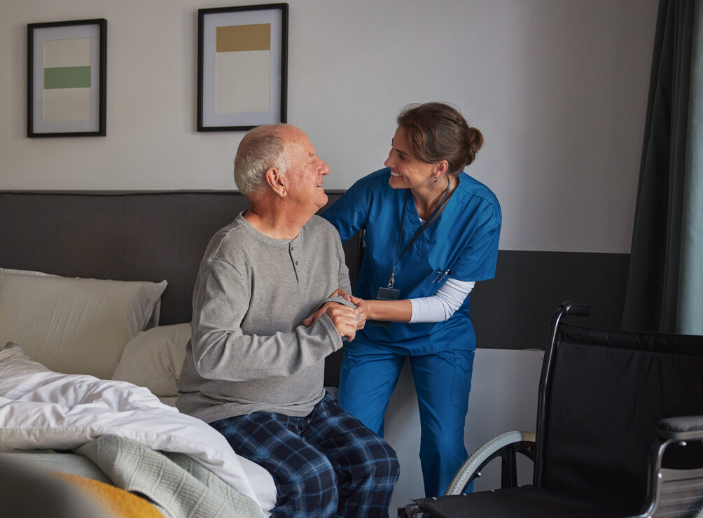 Nurse Helping Senior Man from Bed