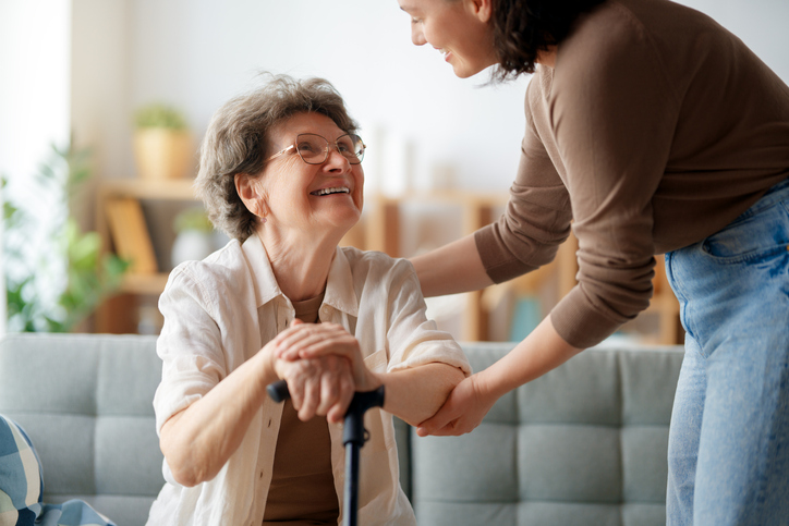 Senior Woman Smiling at Caretaker